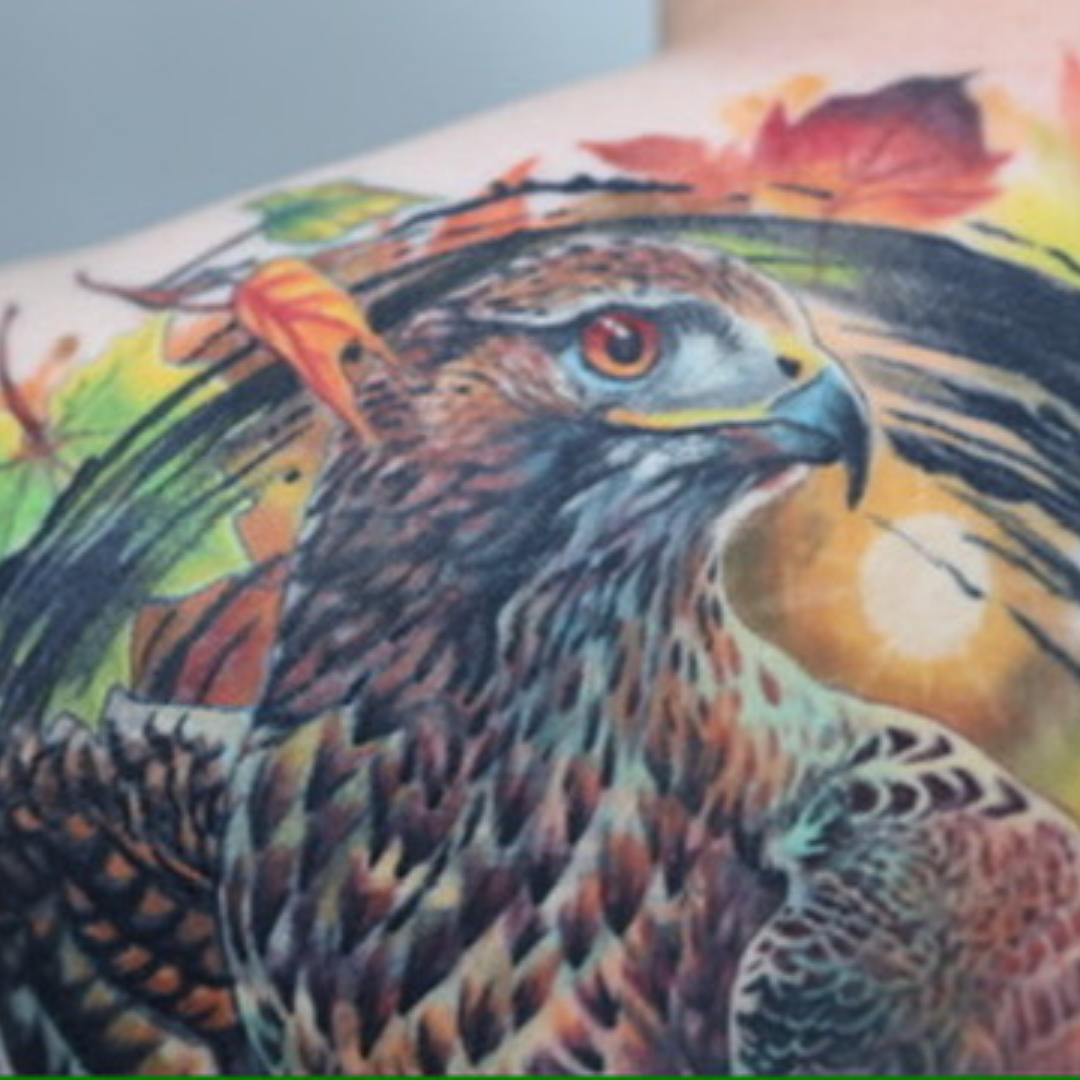 Red-tailed hawk with autumn leaves — hyper-realistic back piece by Zennie